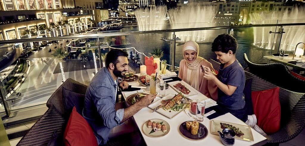family enjoying food at the Dubai Fountain