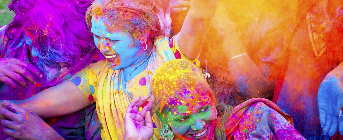 girls throwing colors fro holi 